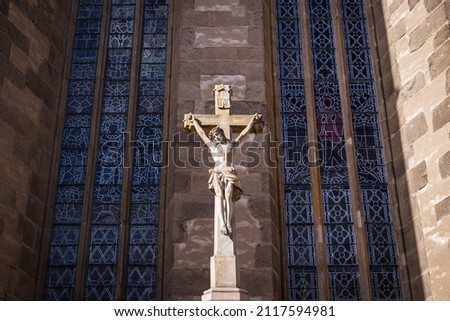 Jesus Christ statue crucified on the cross near the church. Christianity religion