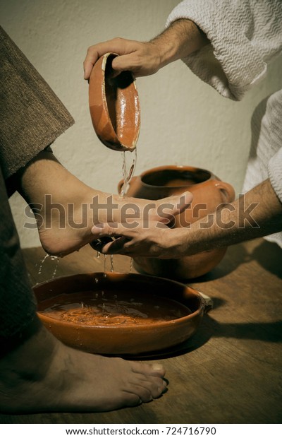 Jesus Christ washing the feet of his disciples in\
sign of humility and\
service