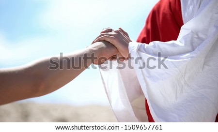 Jesus holding male hand to bless and heal Christian, religious miracle, closeup