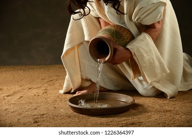 Jesus pouring water from a jar before washing his disciples feet