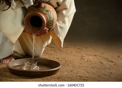 Jesus pouring water from jug over dark background