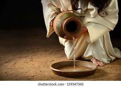 Jesus pouring water from jug to pan to wash feet of disciples