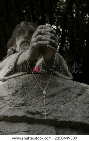 jesus with a rosary in his hand, catholic sculpture