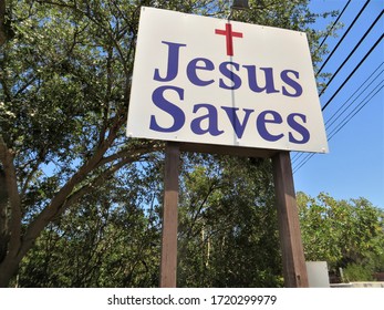 JESUS SAVES sign on roadside.