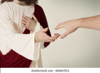Jesus saving hand reaching for the faithful 