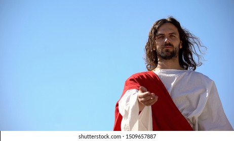 Jesus in white robe stretching hand against blue background, asking Lord help