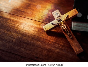 Jesus's crucifix over bible on wooden table background,Christian world mission concept,  copy space