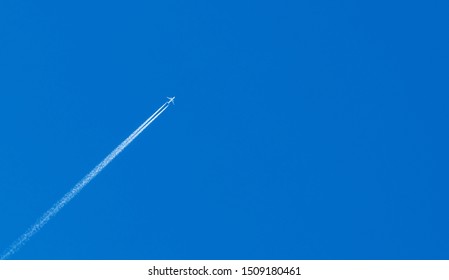 Jet aircraft crossing blue sky - Powered by Shutterstock