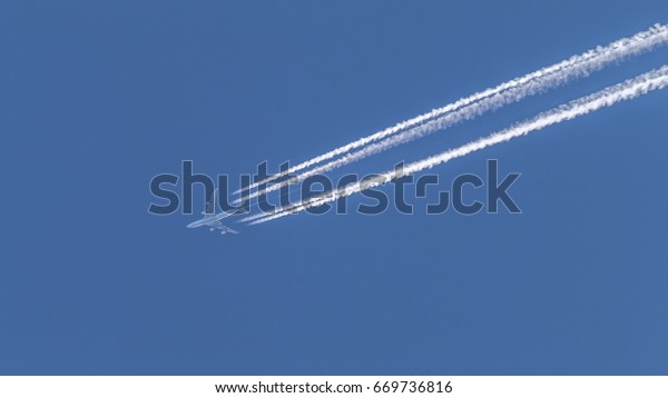 Jet Airplane Flying Across Pure Blue Stock Photo Edit Now 669736816