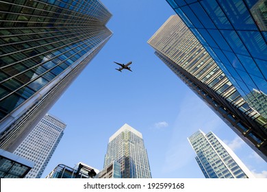 A Jet Airplane Silhouette With Business Office Towers Background