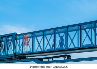 Jet Bridge At The Airport Is Brought To A Large Passenger Plane For Passengers To Exit