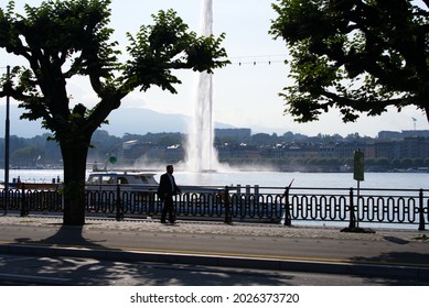 Jet d'eau at Lake Geneva on a sunny summer morning with backlight and Swiss alps in the background. Photo taken July 29th, 2021, Geneva, Switzerland.