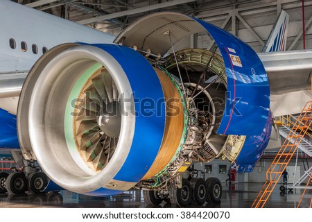 Jet engine open and ready for maintenance inside hangar
