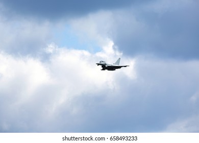 Jet fighter flying high. Dramatic sky in the background.
