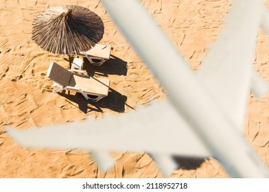 Jet Liner Is Flying Over The Beach At Sunset