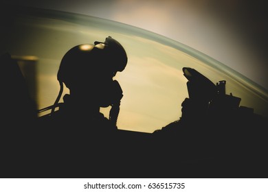 Jet Pilot , Clothing For Pilots Or Pilots Suit , The Military Pilot In The Plane In A Helmet In Dark Blue Overalls Against The Blue Sky