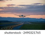 Jet plane landing at an airport at dusk
