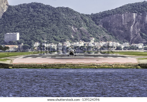 Jet ready to take off against Sugar Loaf mountain\
in Rio de Janeiro