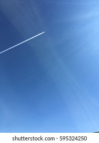 Jet With Stream In Blue Sky