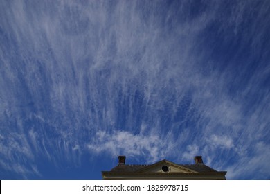 Jet Stream Cloud Strata Over Roof Top