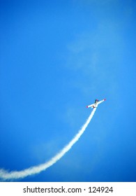 Jet Stream Coming Out Of A Plane In A Blue Sky