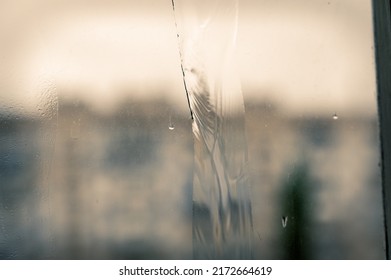 A Jet Of Water On A Dirty Window Pane. Blurred And Unfocused Background. Selective Focus.