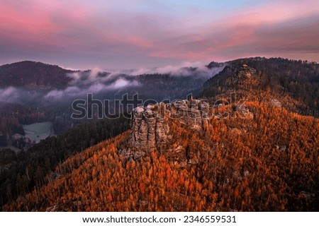 Jetrichovice, Czech Republic - Aerial panoramic view of Bohemian Switzerland National Park with Mariina Vyhlidka (Mary's view) lookout and foggy Czech autumn landscape and colorful pink sunrise sky