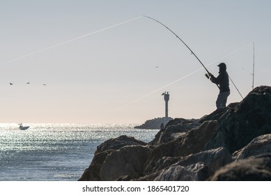Jetty fishing fishermen silhouette in Half Moon Bay California