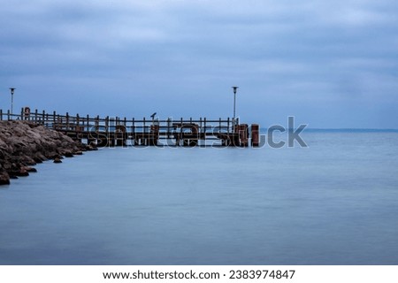 Jetty leads into the water from the side. Clinic on the Müritz