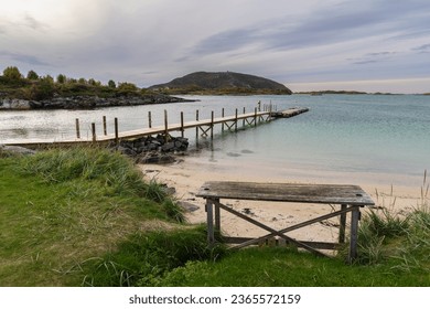 Jetty on the Atlantic near Sommarøy, Norway. Sandy beach with barbecue area and relaxation area, by the turquoise sea, surrounded by flowers and bushes. like in the Caribbean! - Powered by Shutterstock