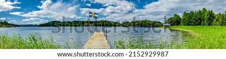 Jetty on a lake in Sweden with a Swedish flag