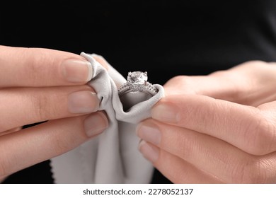 Jeweler cleaning diamond ring with microfiber cloth, closeup - Shutterstock ID 2278052137