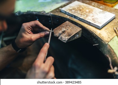 Jeweler crafting jewelry on his workbench