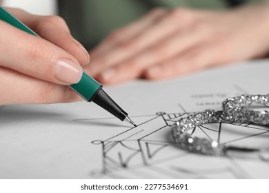 Jeweler drawing sketch of diamond on paper, closeup - Powered by Shutterstock