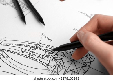 Jeweler drawing sketch of elegant ring on paper, closeup - Powered by Shutterstock