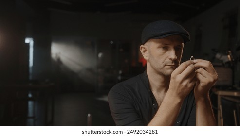 Jeweler examining gold ring through loupe - Powered by Shutterstock