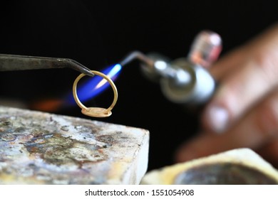 Jeweler goldsmith preparing  gold ring