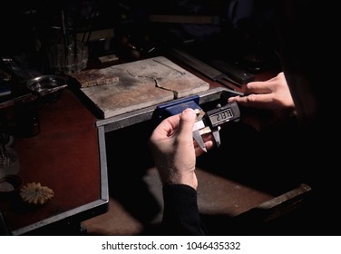 Jeweler measuring golden ring with digital caliper, closeup - Powered by Shutterstock