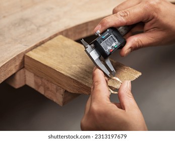 Jeweler measuring a metal ring with a caliper - Powered by Shutterstock