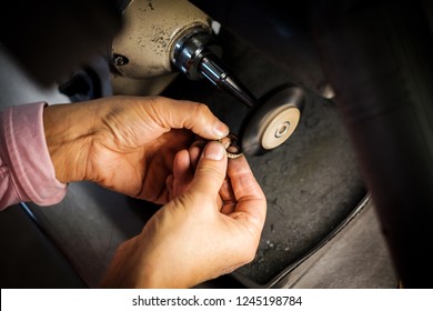 Jeweler Polishes A Gold Ring On A Bench Grinder In An Authentic Jeweller's Workshop