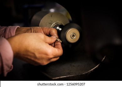 Jeweler Polishes A Gold Ring On A Bench Grinder In An Authentic Jeweller's Workshop