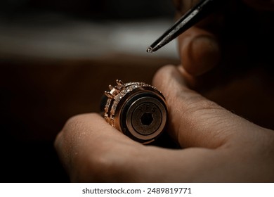 Jeweler puts diamond to golden wedding luxury ring. - Powered by Shutterstock