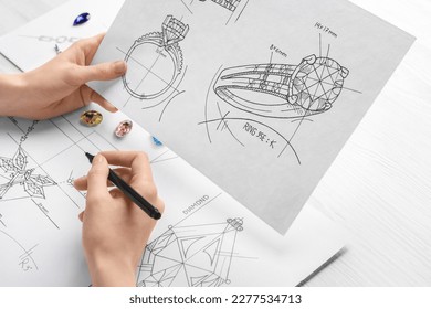 Jeweler with sketches of elegant jewelry at white wooden table, closeup - Shutterstock ID 2277534713