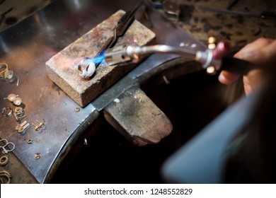 Jeweler Soldering On Work Bench A Gold Ring With Flame From Welding Torch In An Authentic Jewelry Workshop