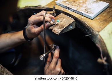 Jeweler using saw to create jewelry