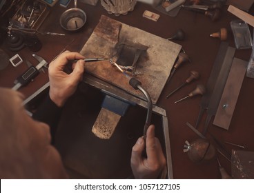 Jeweler working with blow torch, closeup