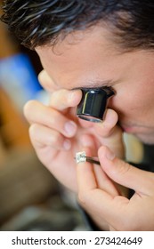 Jeweller appraising a ring