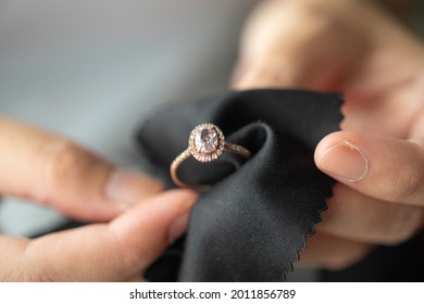 Jeweller cleaning jewelry diamond ring with fabric cloth - Shutterstock ID 2011856789