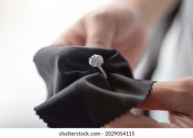 Jeweller Cleaning Jewelry Diamond Ring With Fabric Cloth