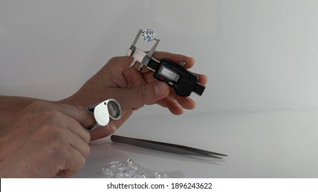 Jeweller Expert Checking Diamonds Using Gauge For Measuring Gemstone Dimensions To Carat Weight For Round Diamond. 